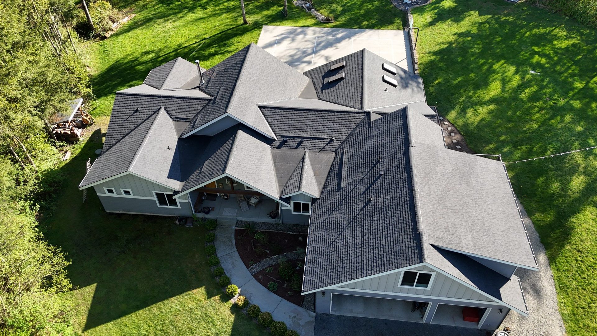 Aerial drone view of completed Charcoal asphalt shingle roof on Lake Stevens, WA home by Amor Roofing