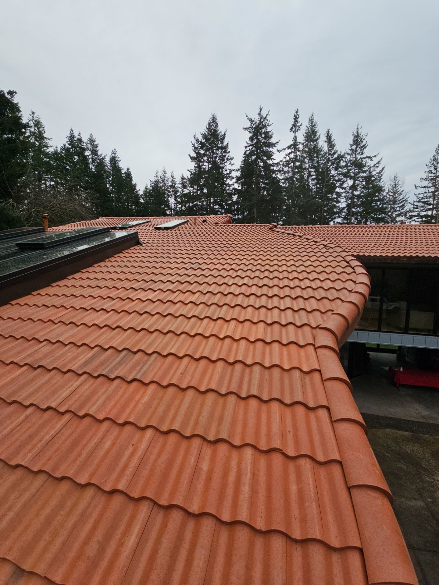 Antique Clay Brava Spanish barrel tile roof installation on Camano Island, WA home, full property context