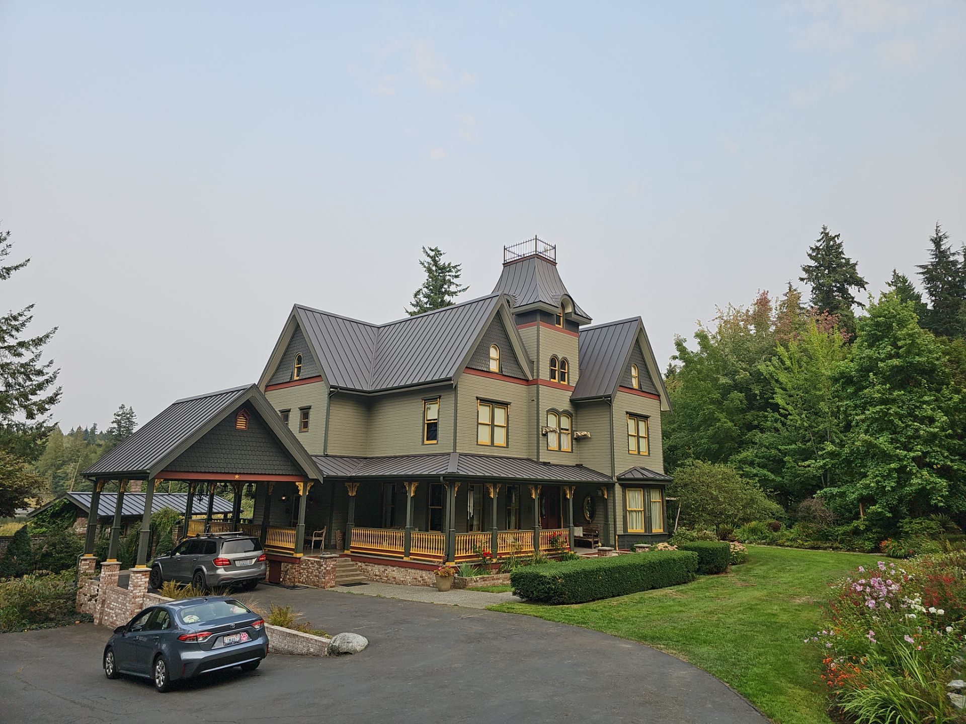 Aerial drone view of completed Black Carbon standing seam metal roof on Stanwood, WA home by Amor Roofing