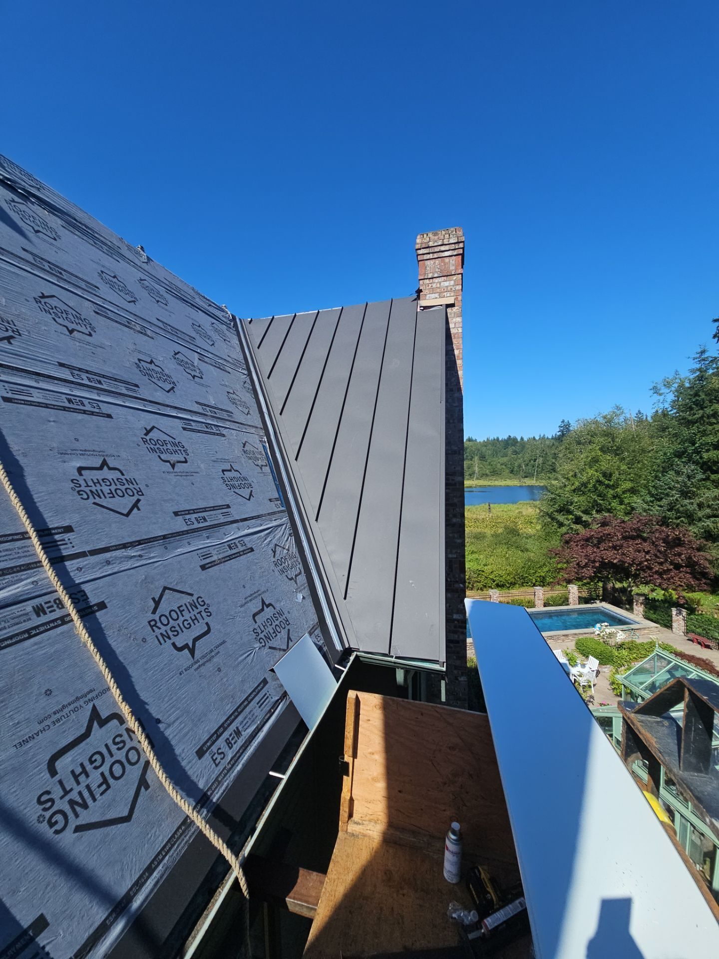 Tear-off and substrate exposure during Black Carbon standing seam metal install in Stanwood, WA
