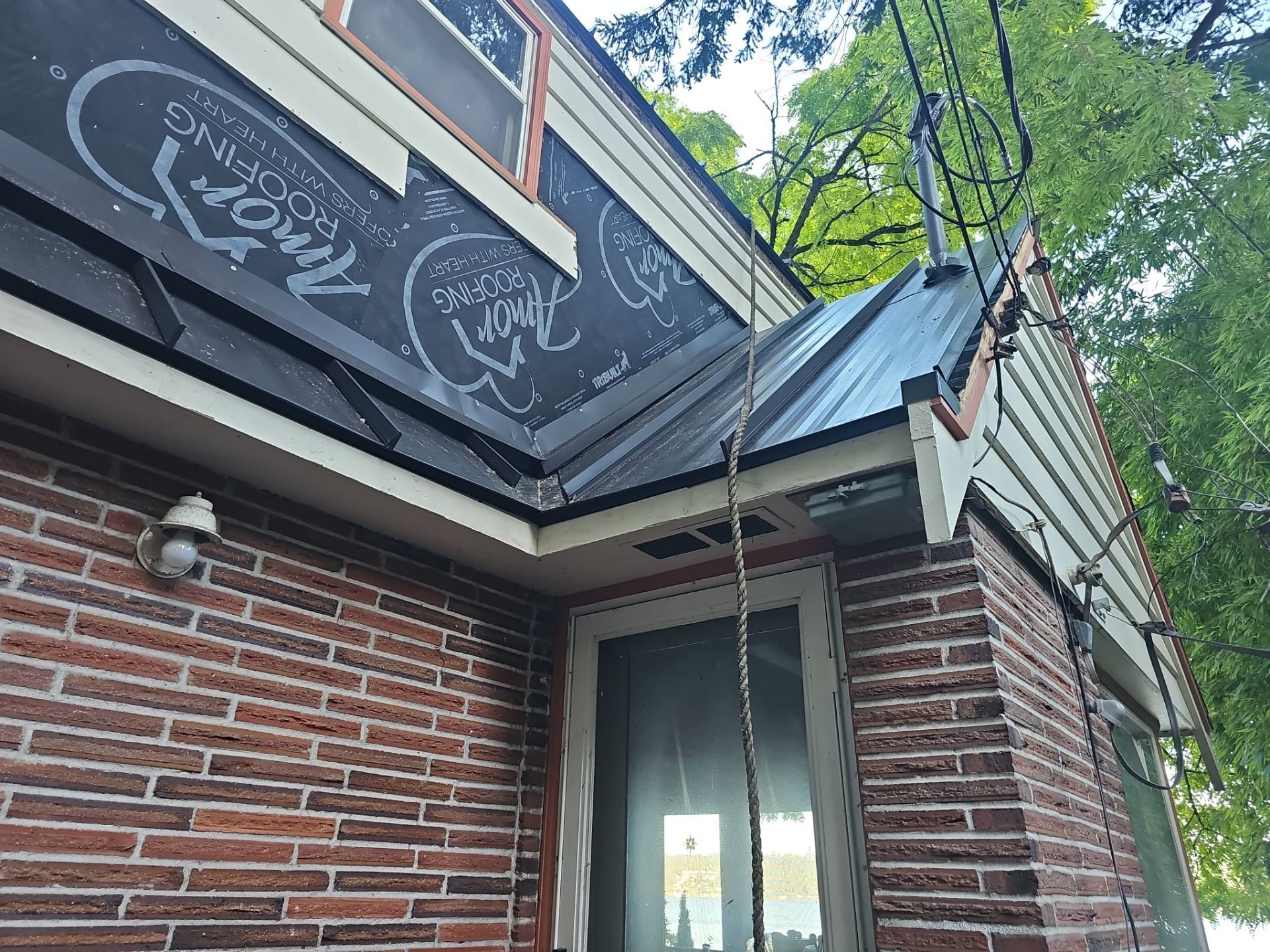 Mid-installation view during Medium Bronze standing seam metal roof project in Bellevue, WA