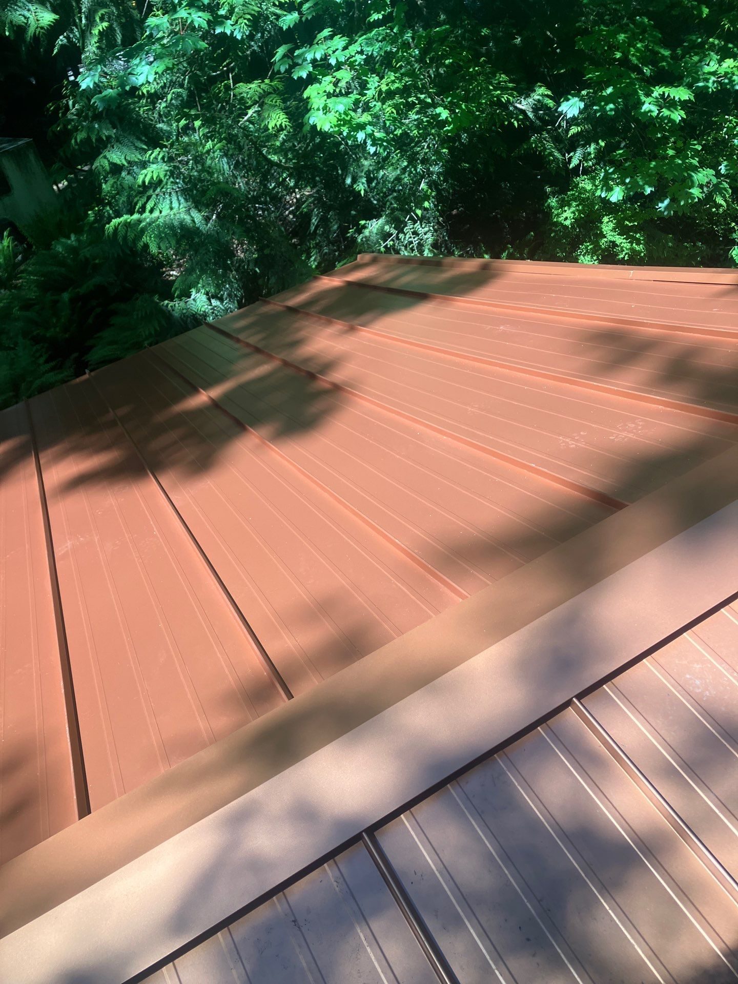 Aerial drone view of completed Copper Penny standing seam metal roof on Marysville, WA home by Amor Roofing