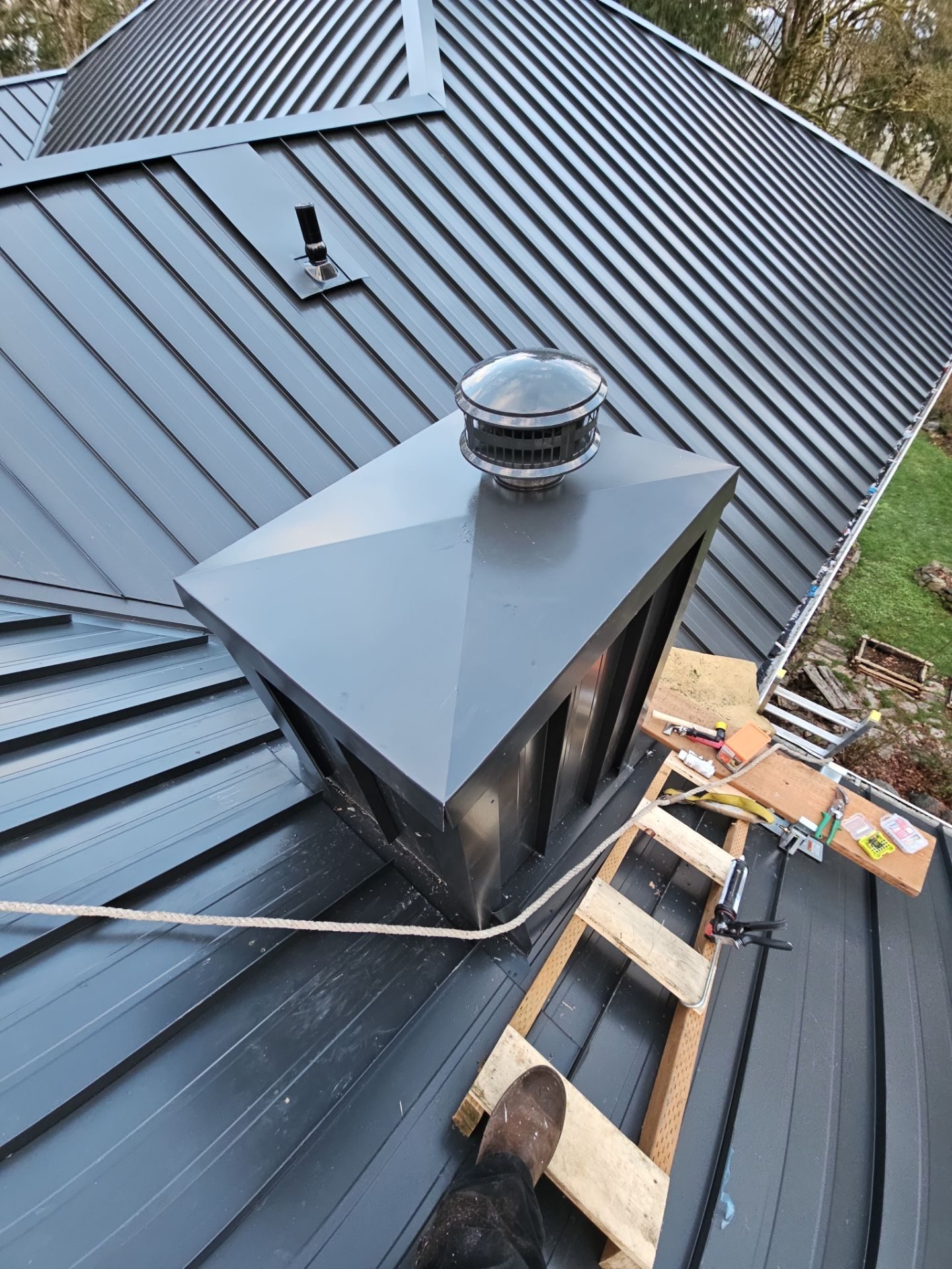 Roof plane detail showing Matte Black standing seam metal pattern in Snohomish, WA