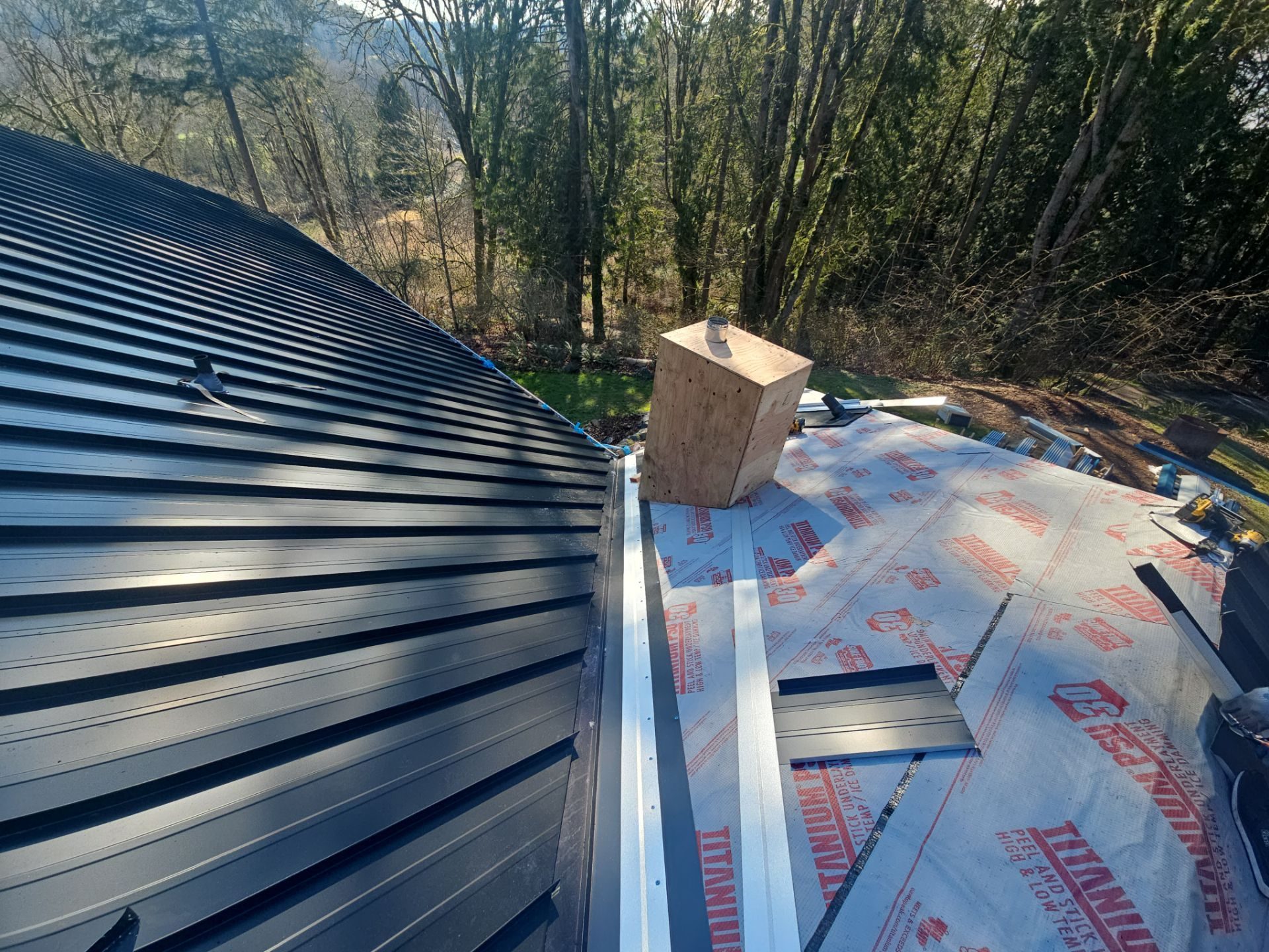 Mid-installation view during Matte Black standing seam metal roof project in Snohomish, WA
