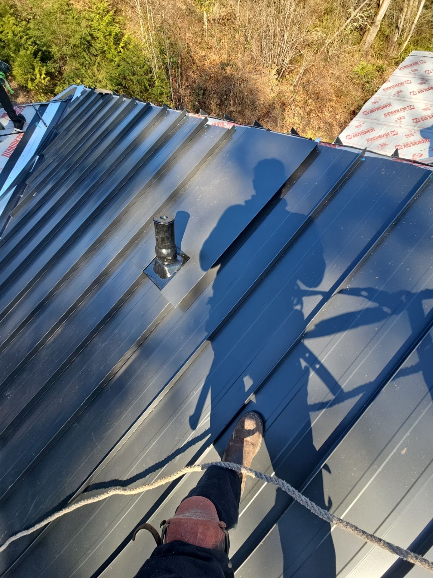 Tear-off and substrate exposure during Matte Black standing seam metal install in Snohomish, WA