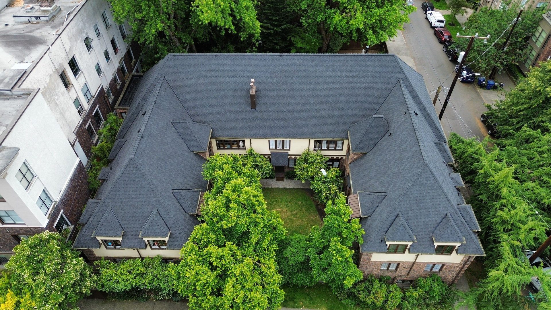 Aerial drone view of completed Charcoal CertainTeed Presidential Shake asphalt shingle roof on Seattle, WA home by Amor Roofing