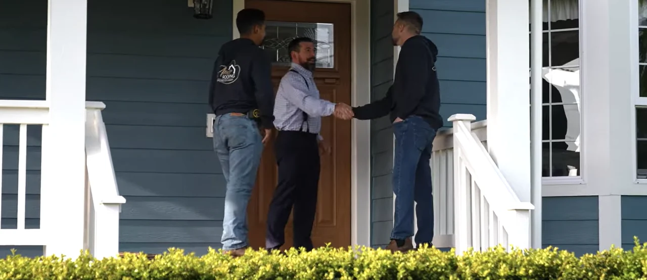 Amor Roofing project consultant greeting a customer at their front door