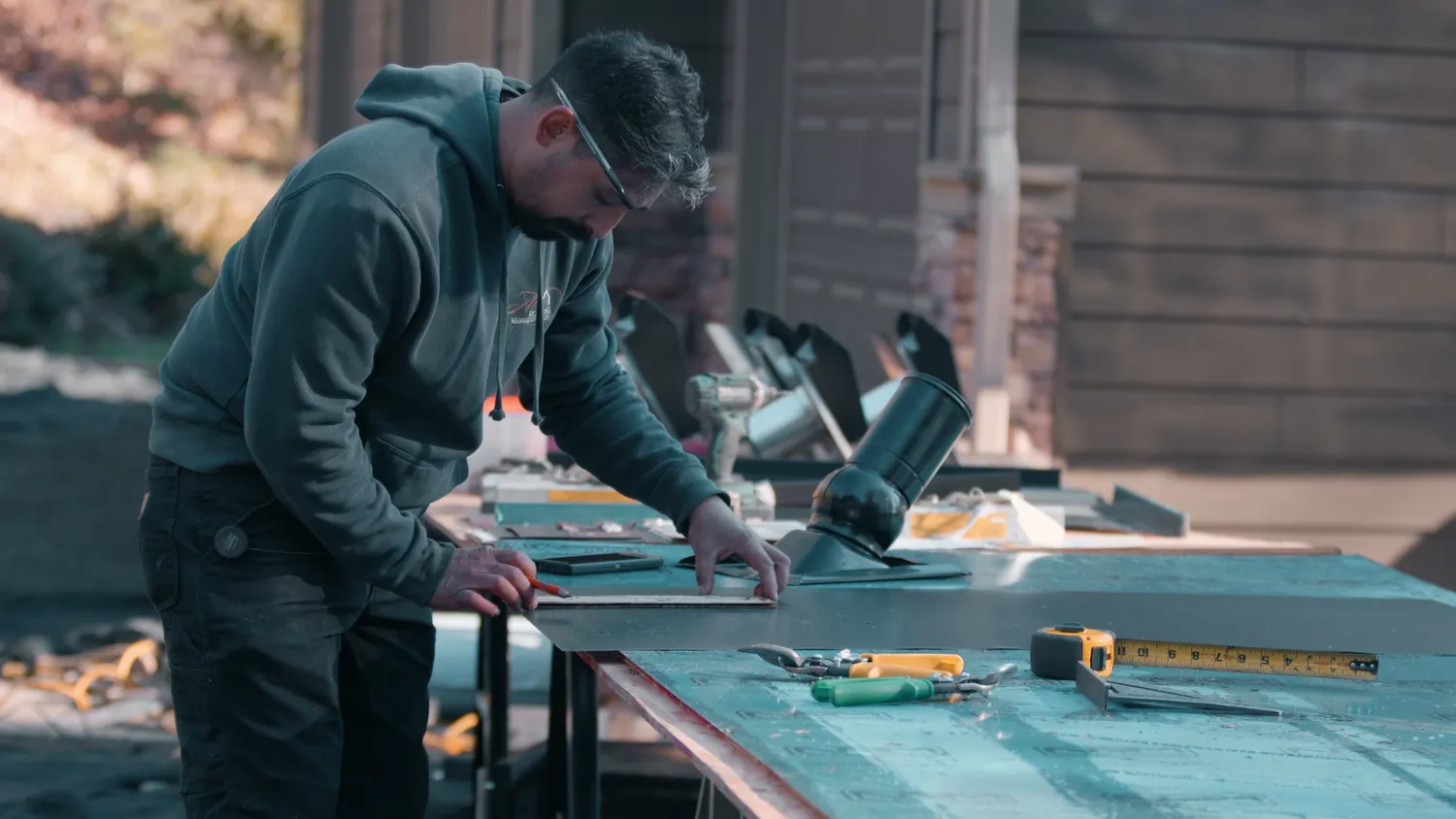 Santiago Rodriguez at his workbench, custom-bending flashing for a metal roof install