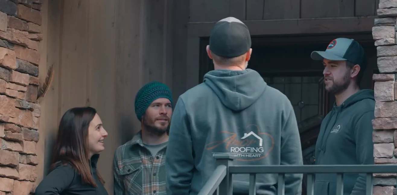 Amor Roofing project consultant explaining a roof repair scope to a homeowner