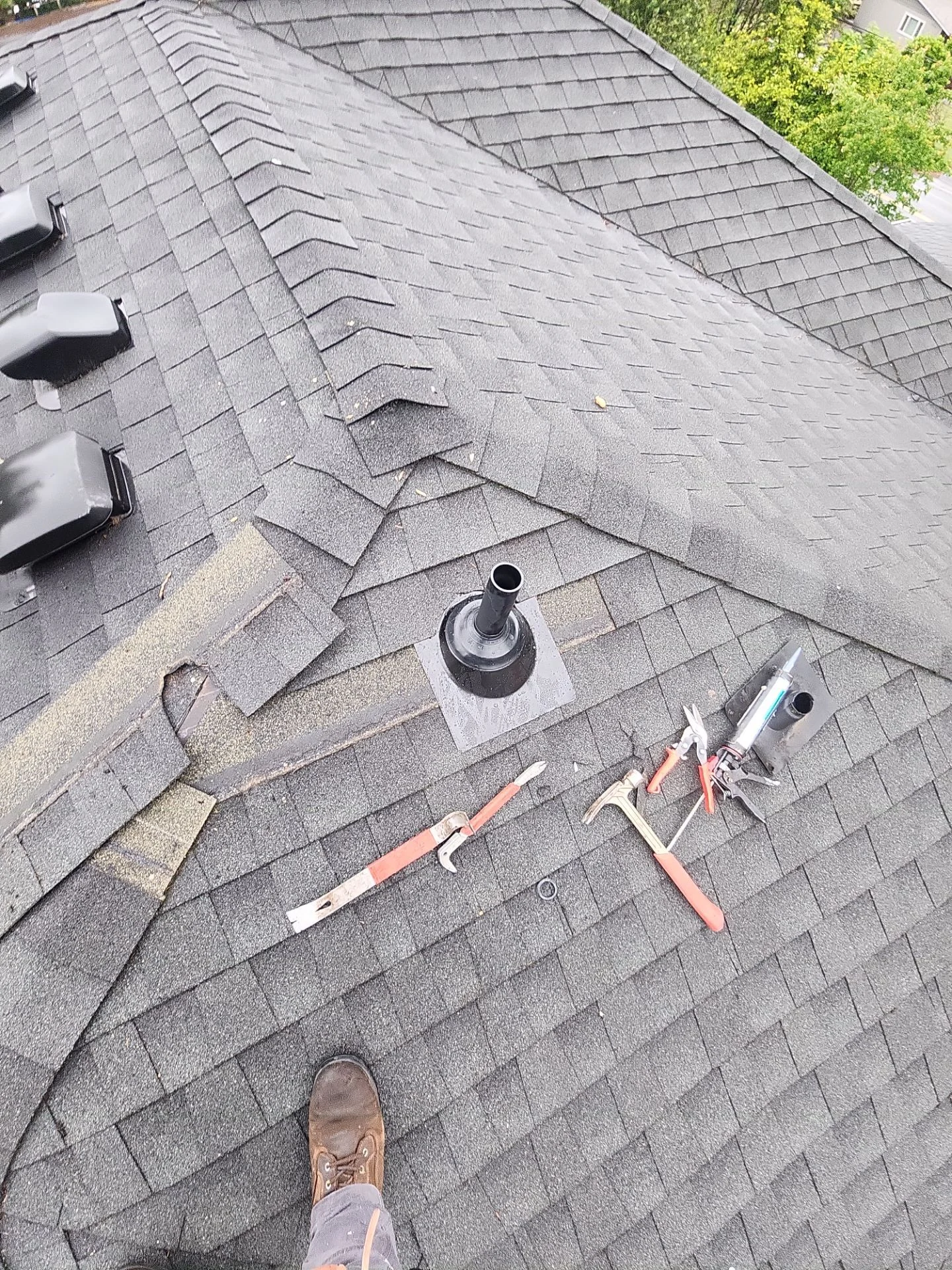 Amor Roofing technician inspecting and repairing a residential roof