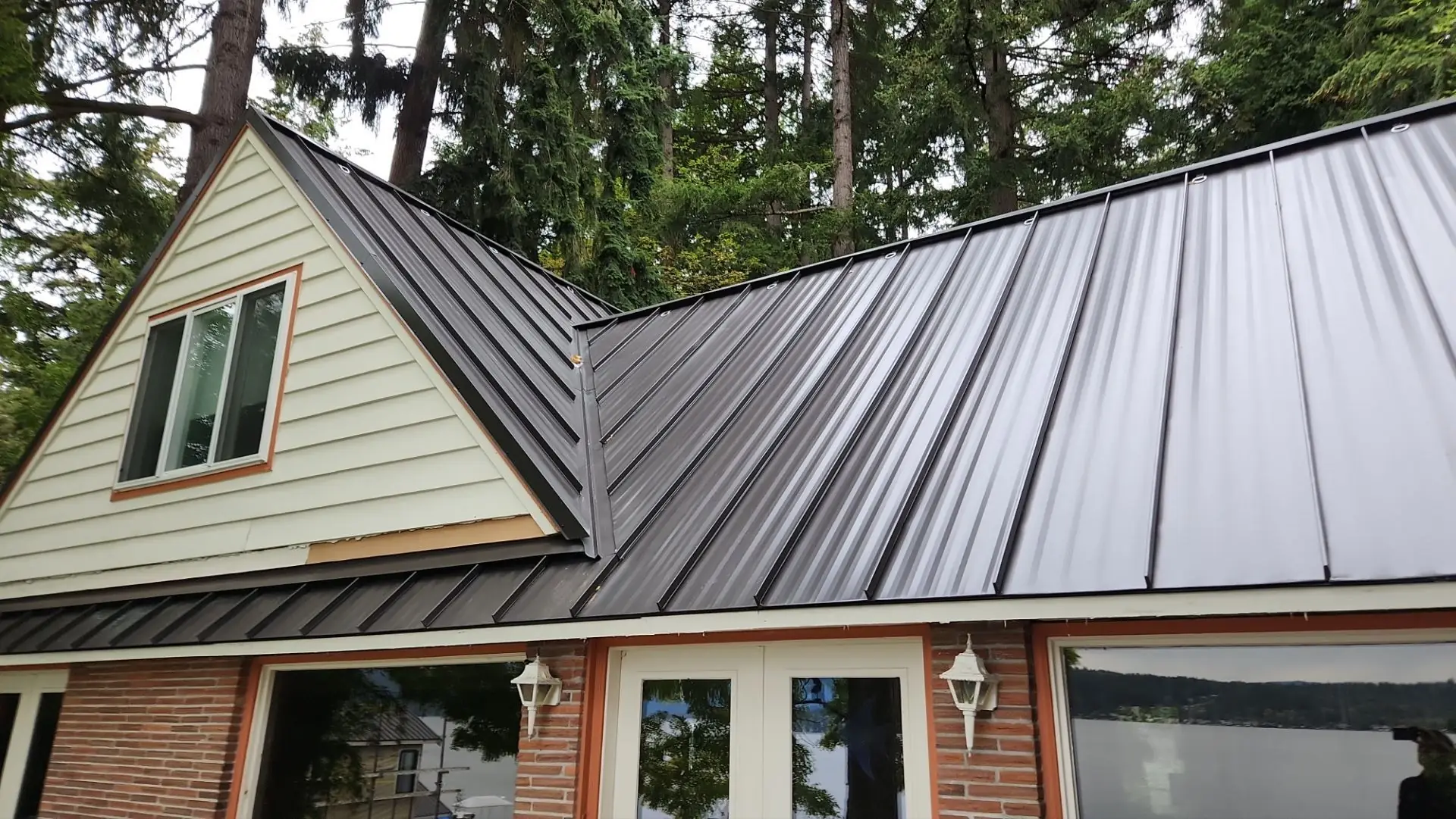 Dark standing seam metal roof on a lakefront home in Bellevue, Washington