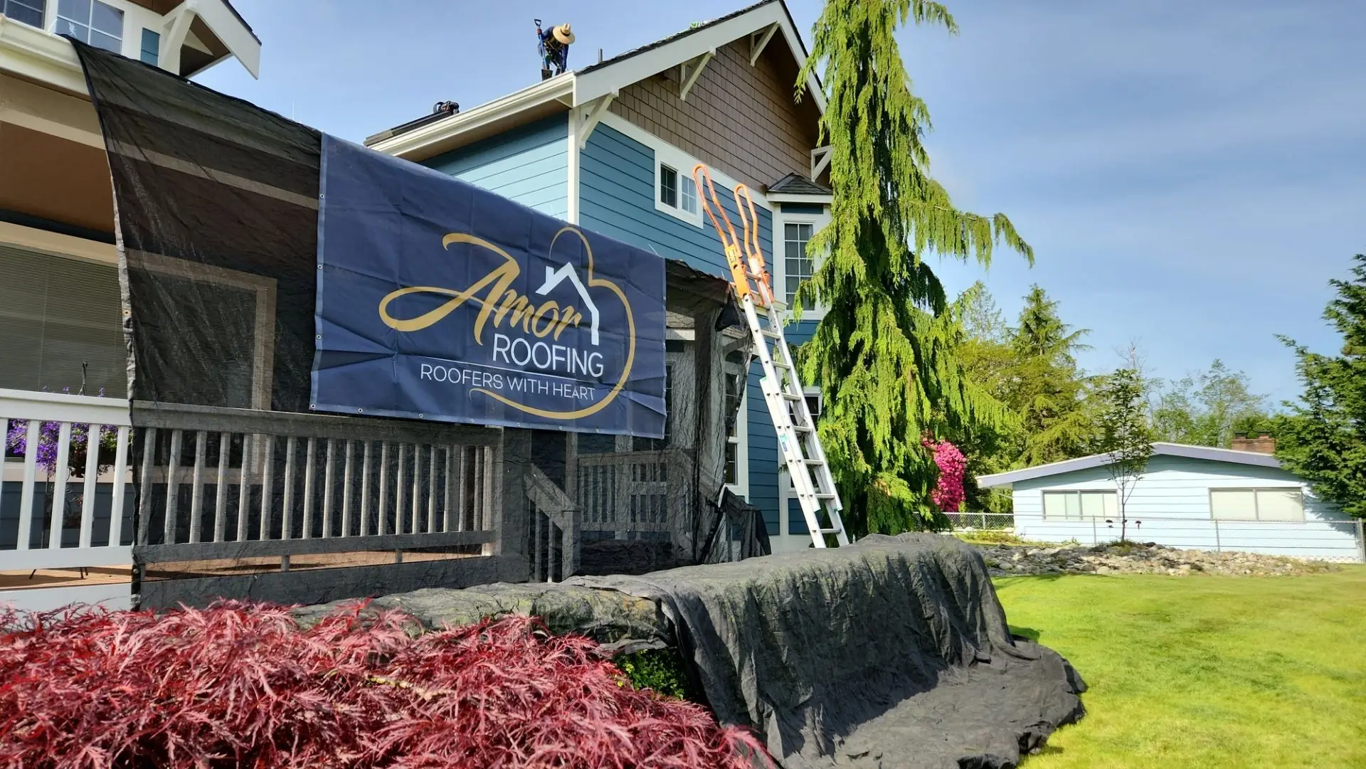 Amor Roofing job site banner outside an Everett, Washington home during a roof replacement