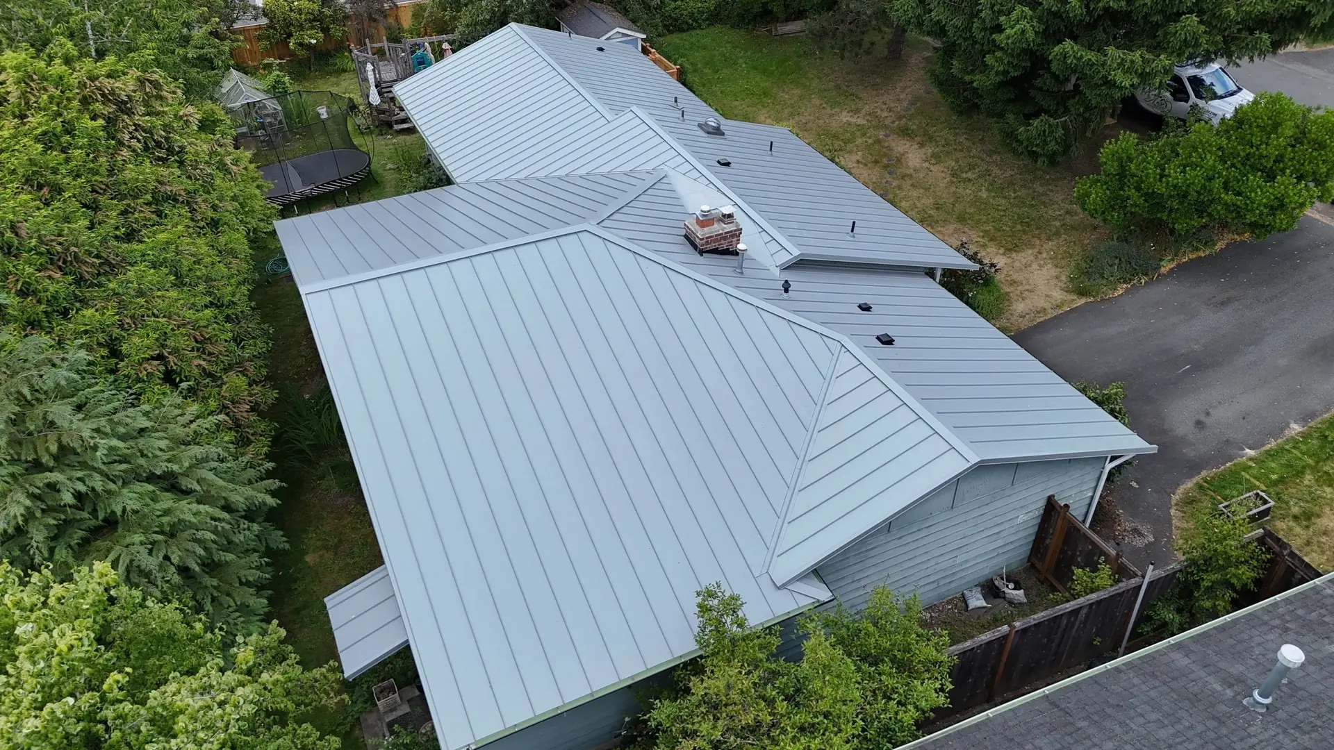 Amor Roofing van at a Kirkland, Washington home with a new standing seam metal roof