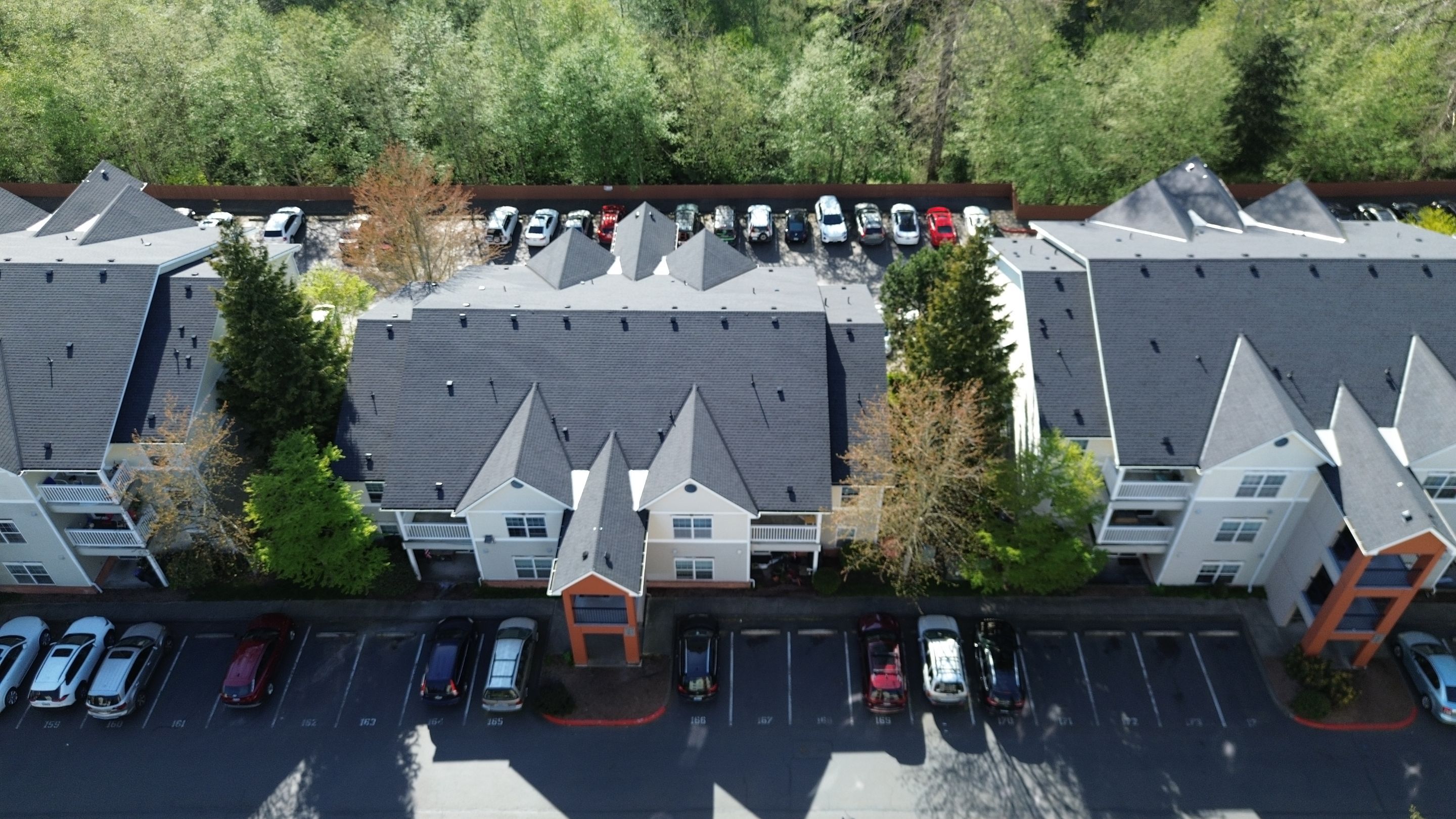 Aerial drone view of multiple Snohomish County buildings with completed asphalt roofs by Amor Roofing